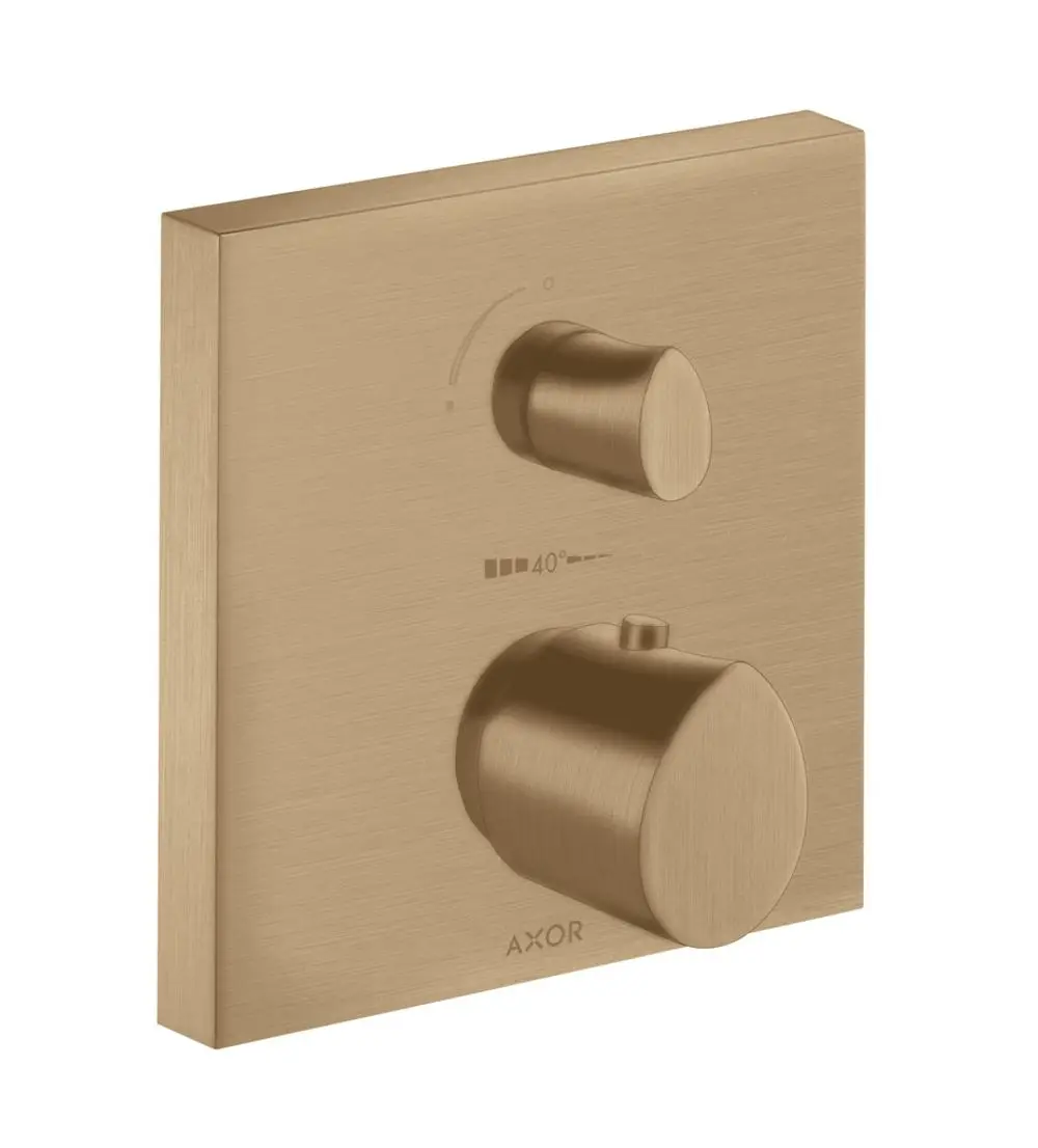 Thermostat mit zwei Reglern zur Temperatur- und Umstellungseinstellung, montiert auf einer quadratischen bronze-farbenen Fläche. Marke AXOR sichtbar.